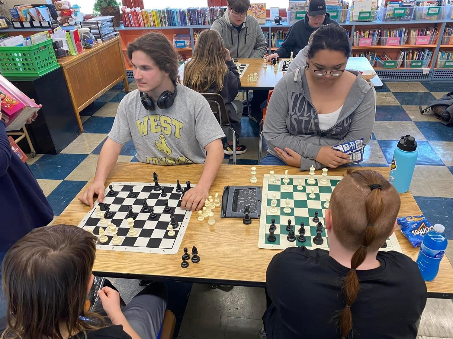 kids playing chess in library 