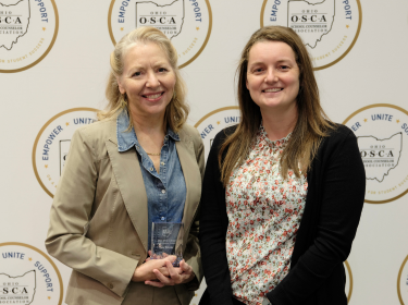 Kate Webster poses for photo with award
