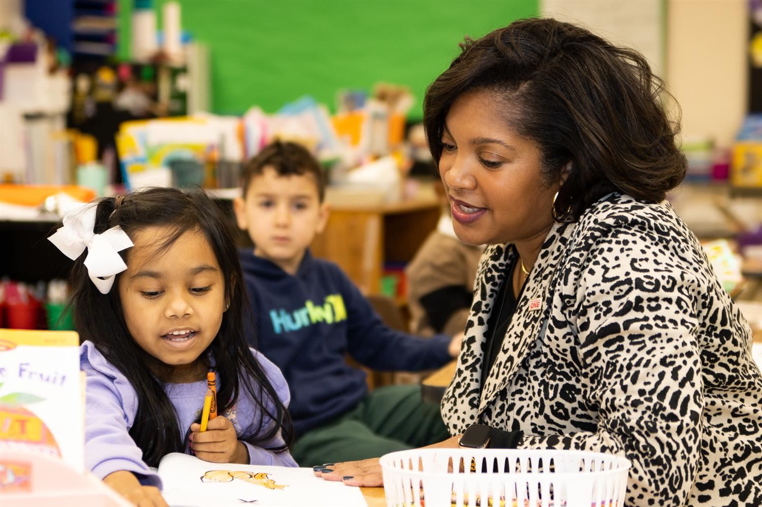 superintendent reading with young female student