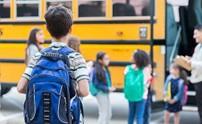 student getting on school bus