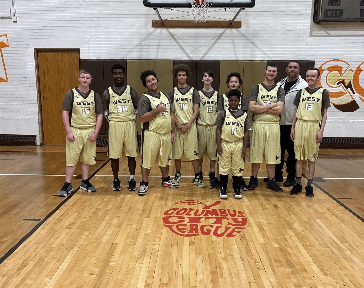  West basketball players by a hoop